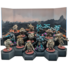 Painted miniatures on 40mm bases across a tiered hex display stand, framed by a lava landscape acrylic backdrop